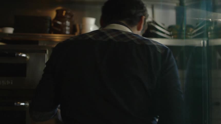 A man works in a commercial kitchen