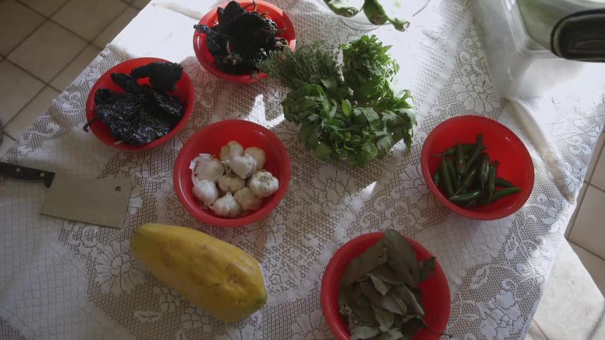 Food is arranged on a table in red bowls