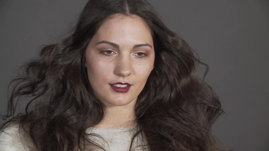 A woman's hair blows in slow motion
