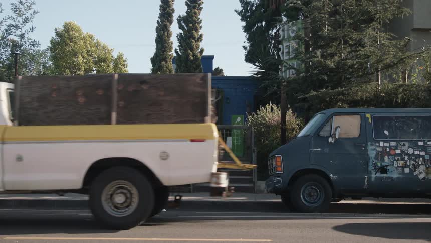 Vehicles move ahead in traffic on the road