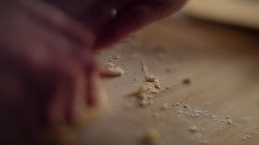 An adult and young child press dough