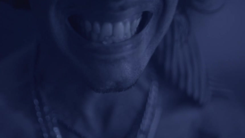 A shirtless person screams in anger mouth wide open
