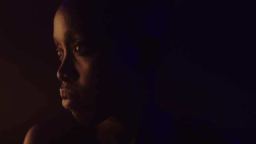 Woman in a dark room with low lighting