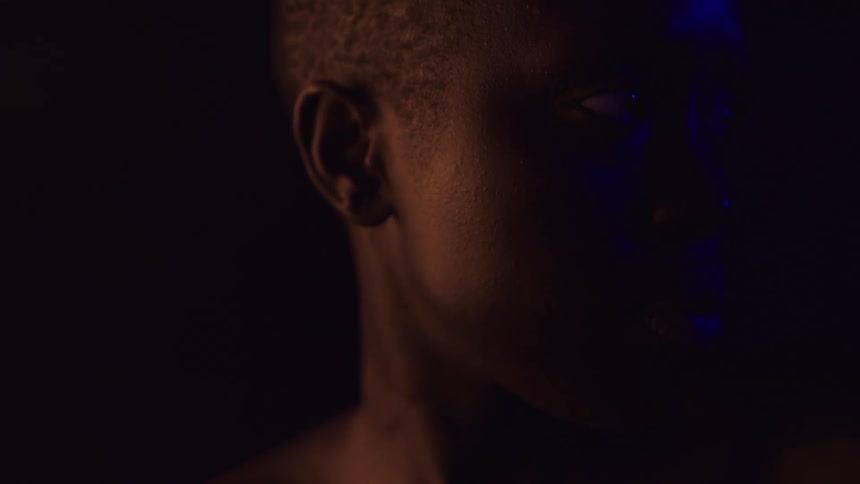 The woman looks forward in the dark