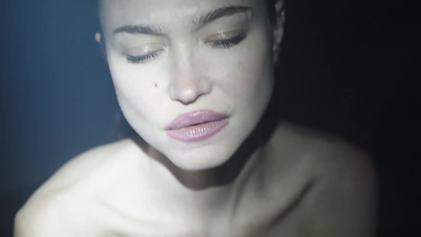 Light flashing brightly on a womans face
