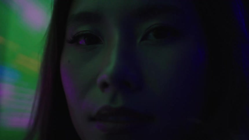 A flashing wall is near the womans face