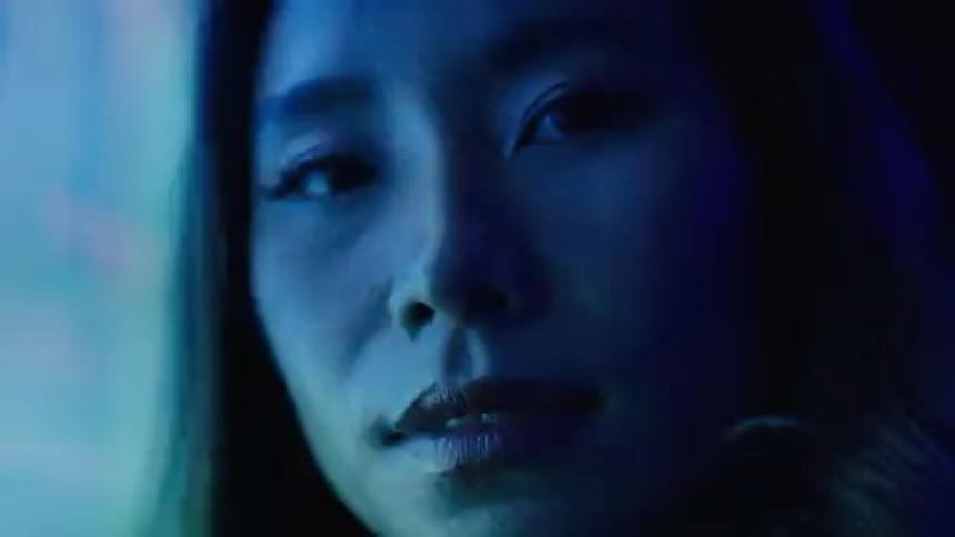 Portrait of a woman next to a light panel