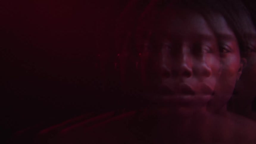 The woman looks sad in the dark room