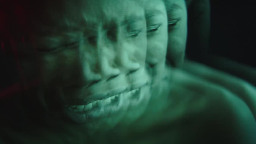 Distorted face in multiple overlays with an expression of pain