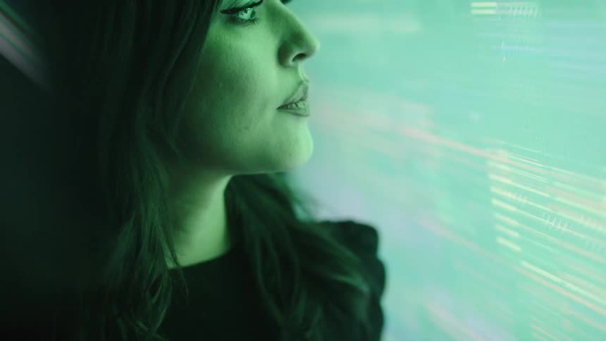 Woman next to a screen displaying lights with different tones