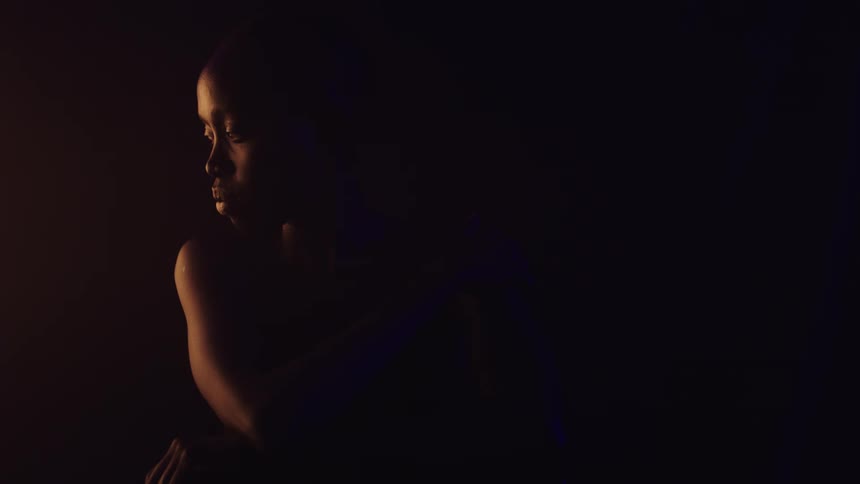 Silhouette figure lit by orange light