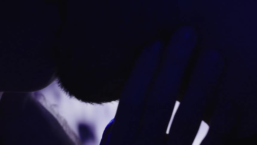 A man and woman are kissing in the dark