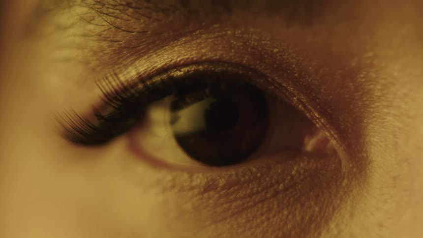 Eye in closeup lit by golden light