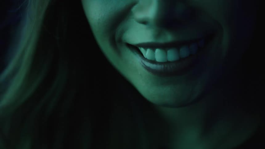 Smile lit by deep blue light