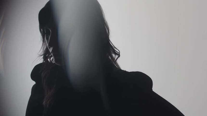 The woman puts both hands on her face