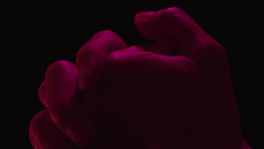 Closeup of a persons hand clenching and unclenching their fists