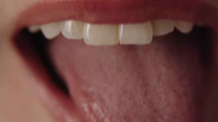 Extreme close up of a woman sticking her tongue out