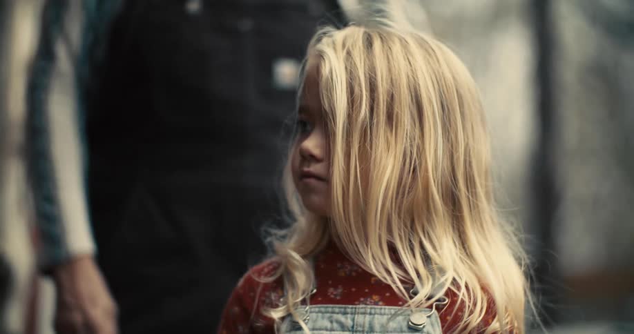 A girl holds a leaf in her hands