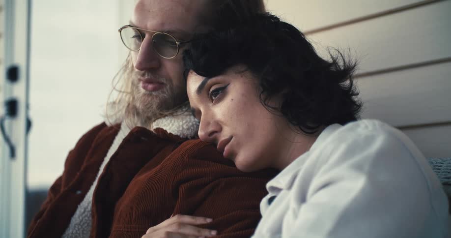 Woman rests her head on a mans shoulder in a moment of comfort