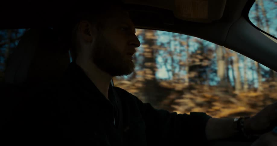 Close up of a young male adult driving a vehicle during daytime