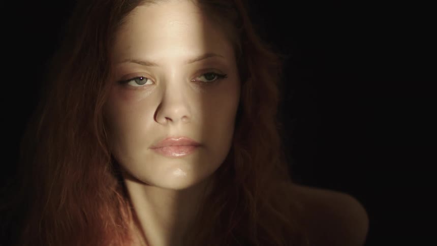 A line of light flashes on the womans face