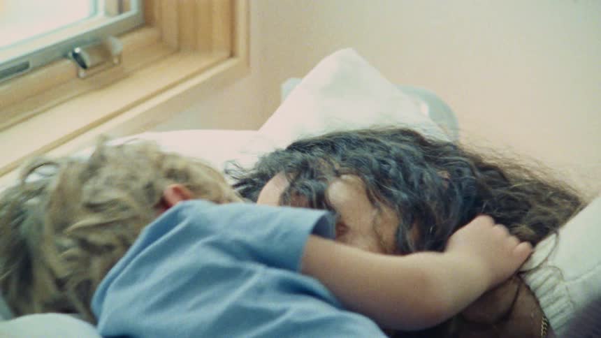 Woman and child lying together in a cozy moment
