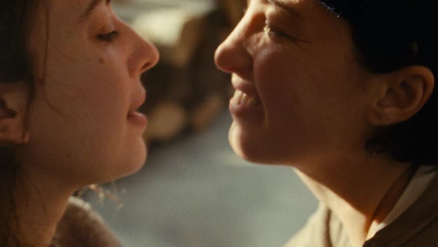 Lesbian couple sharing a romantic kissindoors