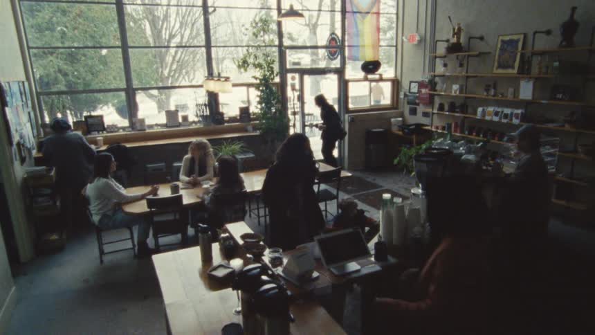 Customers enjoy coffee together at a cozy cafr on a lively morning
