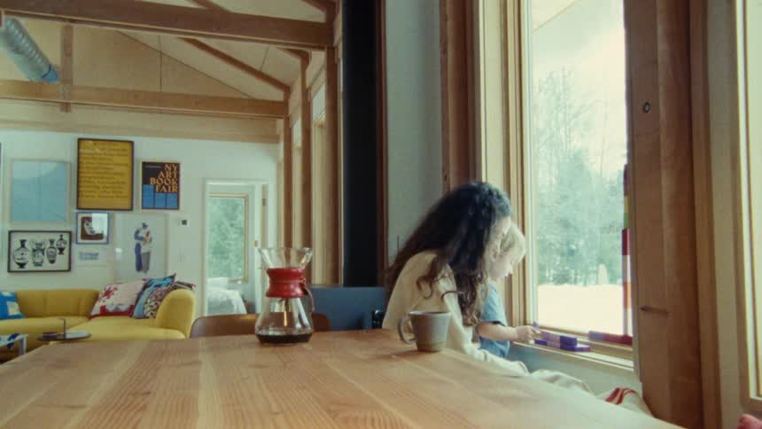 Mother and son play by a window in a cozy wooden home