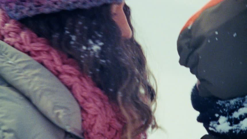 Mother and child playing in the snow having fun