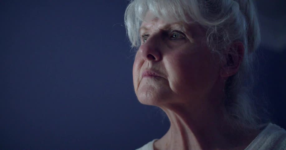 A woman looks around thinking