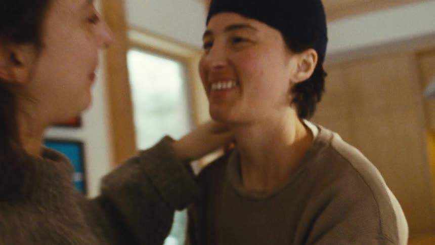 Close up of a young couple holding each other while standing in a living room during daytime