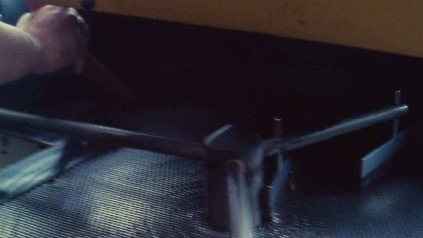 Hand using brush on instrument surface