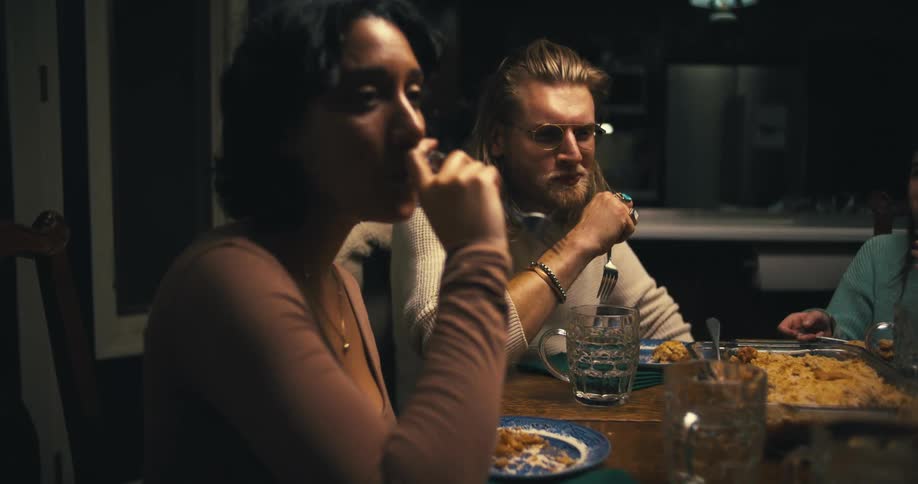 A family sits around a dinner table eating together