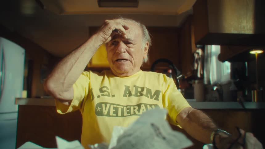 A man stresses over a pile of papers and receipts