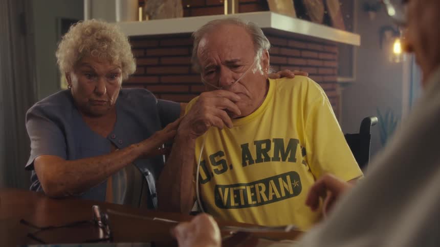 An elderly couple gets emotional as a doctor shows a report