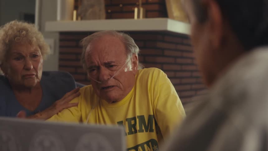 Close up of a doctor explaining brain ct results to a sad crying couple in a living room during daytime