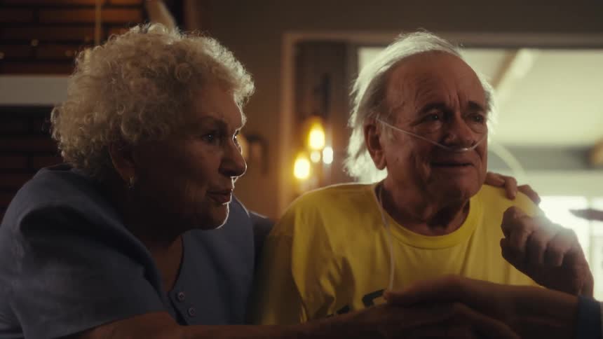 An elderly couple in a doctors office talking with the doctor