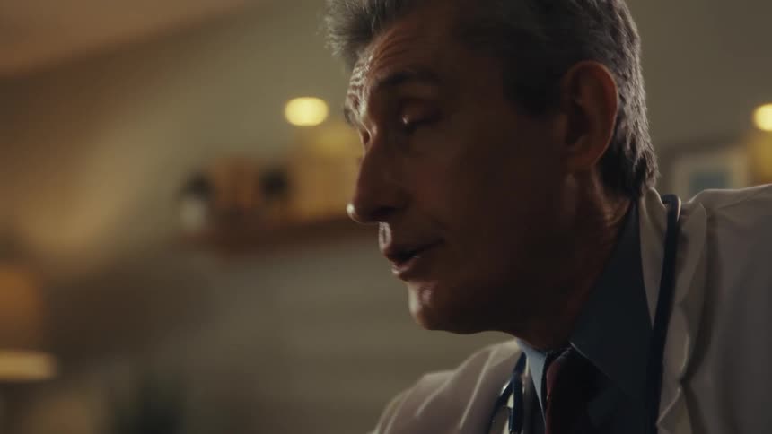 A doctor places his hand on an elderly man while explaining his medical condition as sadness and fear fill the mans face the elderly man is wearing a nasal cannula