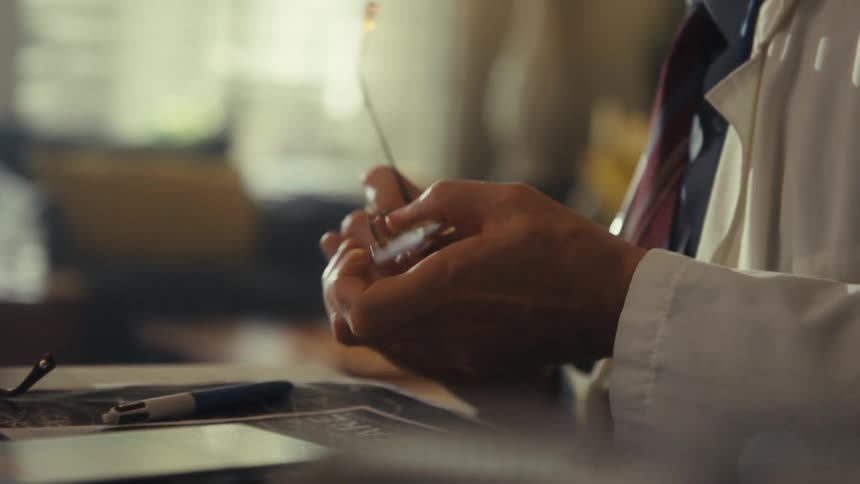 The doctor is reading paperwork with a patient