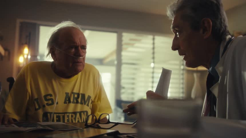 Doctor explains health report to an elderly couple at home