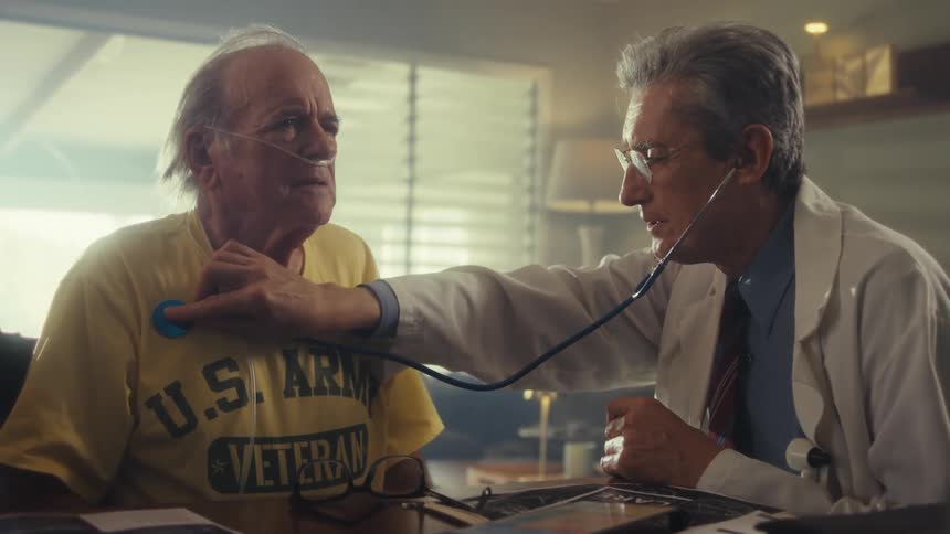 The doctor is using a stethoscope on a patient