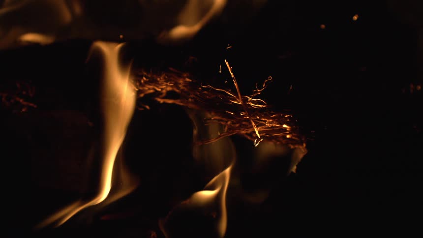 Flames consuming pieces of burning wood