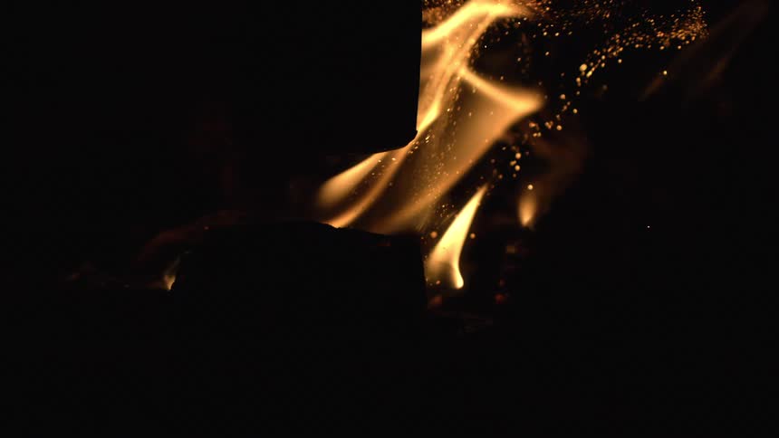 Close up of flames burning at night in slow motion
