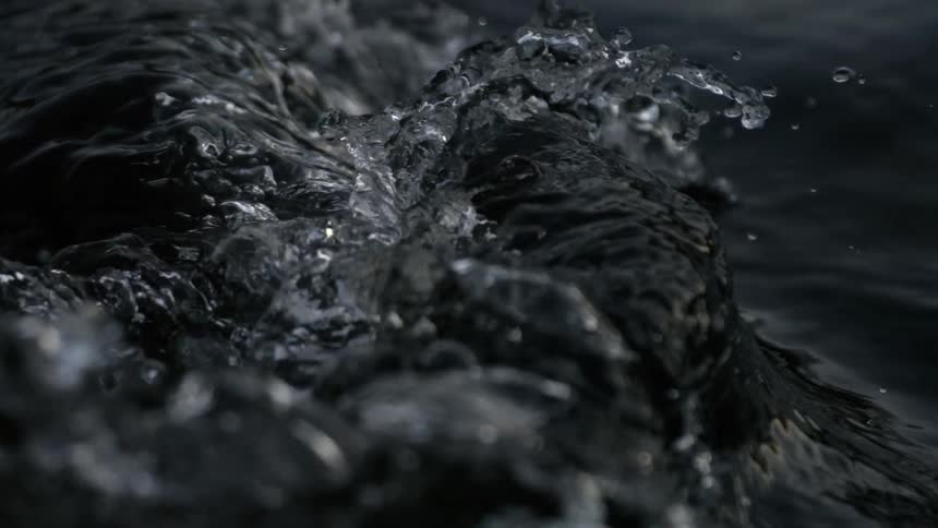 Extreme close up of water boiling and bubbling in super slow motion