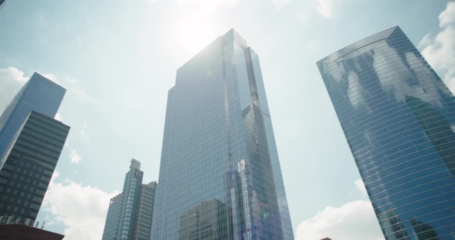 The sun reflects on the skyscrapers