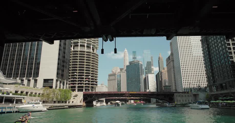 Boats travel in the water running through the city
