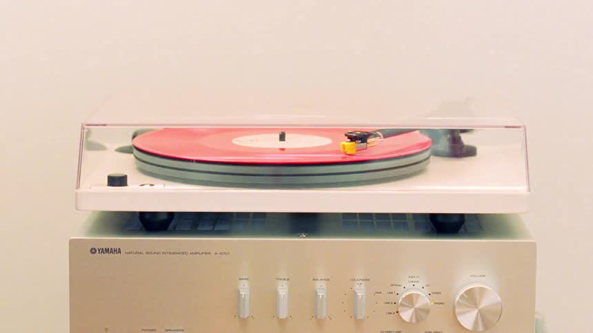 Vinyl record spinning on a retro stereo
