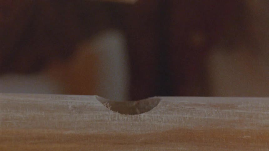 Wooden dowel being fitted into a hole during handcrafted work