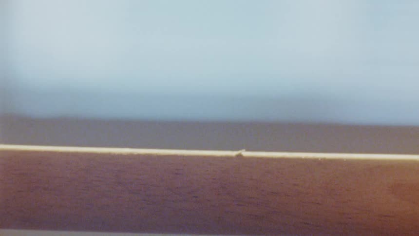 A person is painting a piece of wood